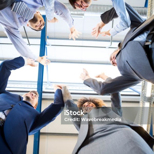 Happy business team high fiving in office